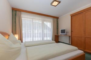 Postel nebo postele na pokoji v ubytování Hotel Garni Elisabeth