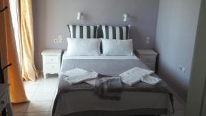 a bedroom with a bed with two towels on it at Katerina Lefkada in Vasiliki
