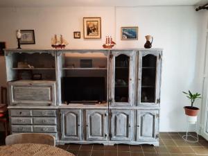 a entertainment center with a television in a living room at Apartment Baratula in Murter