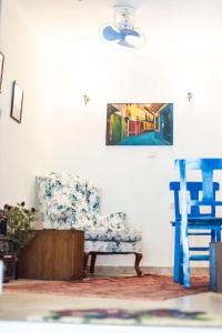 a room with a chair and a painting on the wall at Kelebek Butik Pansiyon in Ayvalık