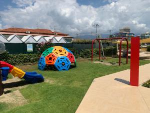 a playground with a play equipment in a park at Stabilimento Balneare Città Giardino - Casa Vacanza in Viareggio