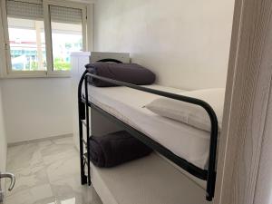 a bedroom with a bunk bed with towels on it at Stabilimento Balneare Città Giardino - Casa Vacanza in Viareggio +23 photos