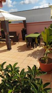 a patio with a table and chairs and plants at Casa vacanze in Casarano