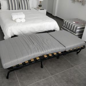 A bed or beds in a room at Nea Stira Studios Kondilia