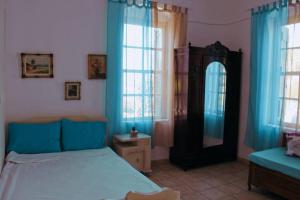 a bedroom with a bed and a mirror at Iliana's courtyard in Evdilos