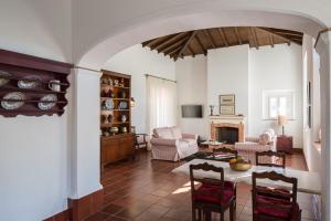 a living room filled with furniture and a fireplace at Hotel Rural Monte da Provença in Elvas