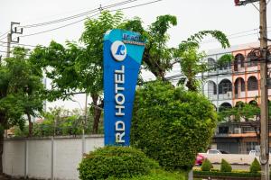 a blue sign for a car dealership at Royal Delight Hotel in Bangkok