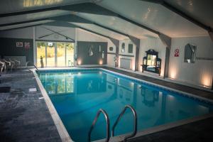 a large swimming pool in a house with at Polmaily House in Drumnadrochit