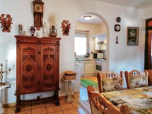 a kitchen and dining room with a large wooden cabinet at Júlia Vendégház in Nyíregyháza