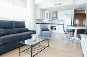 a living room with a couch and a table at Sotavento Atico Calpe in Calpe