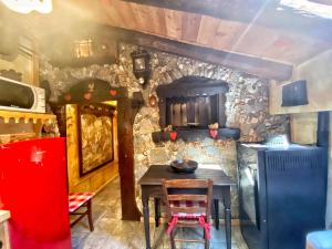 a kitchen with a table and a stone wall at La Maisonnette de Stefano in Pré-Saint-Didier