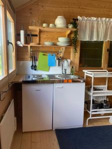 a small kitchen with a sink and a counter at Asplunda Gård,Kolmården, stuga nr 4 in Kolmården