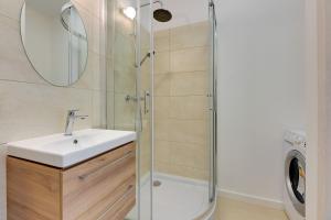 a bathroom with a sink and a shower at Grand Apartments - Studio Apartment 50 m from Monte Cassino in Sopot +9 photos