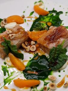 a white plate of food with vegetables and meat at Hotel Miramare & Spa in Sestri Levante