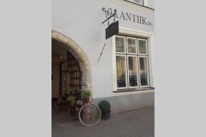 a bike parked outside of a white building at Old Town Baltic Antique Lai street Privat entrance in Tallinn