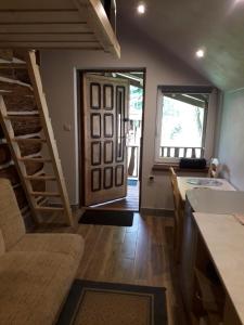 a kitchen with a staircase and a living room at agrohaczów zarzeką apartament pod orzechem in Haczów