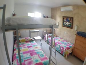 a small room with two bunk beds and a desk at Bahía 66 in Empuriabrava +21 photos