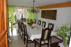 a dining room with a table and chairs at Willa Panorama in Szczyrk