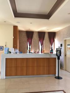 a lobby with a reception counter with red drapes at Vagia Mare in Gerani