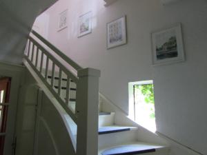 a staircase in a house with a stair case at Dům u rybníka in Nýdek +28 photos