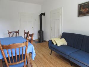 a living room with a couch and a table and a stove at Dům u rybníka in Nýdek +27 photos
