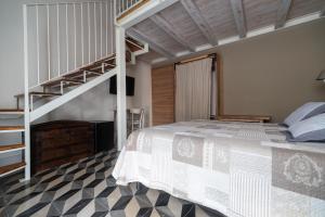a bedroom with a bunk bed and a staircase at La corte dei tre in Torre del Lago Puccini