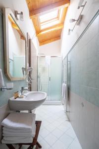a bathroom with a sink and a glass shower at La corte dei tre in Torre del Lago Puccini