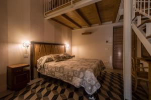 a bedroom with a bed in a room with a staircase at La corte dei tre in Torre del Lago Puccini