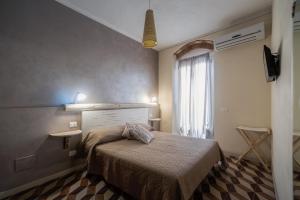 a bedroom with a bed and a window at La corte dei tre in Torre del Lago Puccini