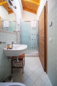a bathroom with a sink and a shower at La corte dei tre in Torre del Lago Puccini