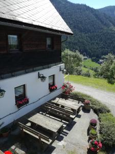 a building with picnic tables in front of it at Biohof Sattler in Etmissl