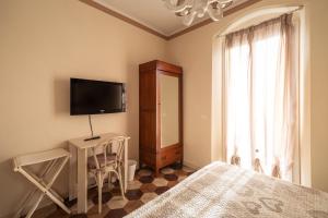 a bedroom with a bed and a flat screen tv at La corte dei tre in Torre del Lago Puccini