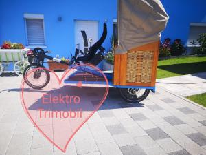 a bike parked next to a sign that says electric tricycle at Privatzimmer Sonne in Bad Säckingen