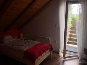 a bedroom with a bed and a large window at Holiday Home Kuća GORICA BLANCA in Fužine