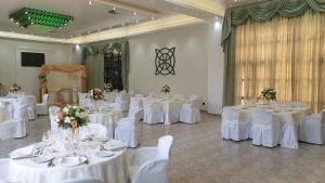 a banquet hall with white tables and white chairs at Palahotel Vallenoce in Decollatura