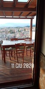 a patio with a table and chairs on a deck at B&B Bella Vista in Dorgali