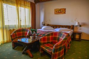 Un pat sau paturi într-o cameră la Cheile Gradistei Fundata Resort
