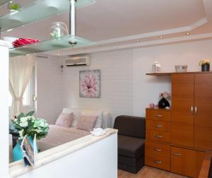 a small bedroom with a bed and a couch at Studio Ami in Zagreb