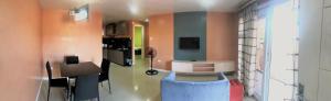 a room with a kitchen with a desk and a table at RL Veranda Suite in Baguio