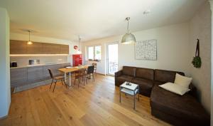 a living room with a couch and a table at Ferienwohnungen Waltraud Trinker, Haus in Haus im Ennstal +14 photos