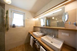 a bathroom with a sink and a mirror at Ferienwohnungen Waltraud Trinker, Haus in Haus im Ennstal