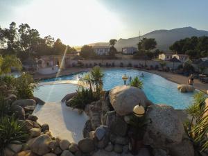 a large swimming pool with a teddy bear in a resort at Camping TIKITI in Propriano