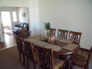 a dining room with a table and chairs and a table and chairsktop at Rainbow Guesthouse in East London