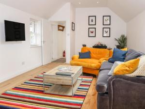 a living room with a couch and a coffee table at Stables Cottage in Heathfield