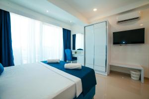 Ένα ή περισσότερα κρεβάτια σε δωμάτιο στο Hotel Ambiente Ulcinj