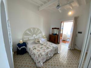 a bedroom with a large bed and a window at Basiluzzo Resort in Panarea