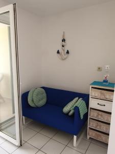 a blue couch in a room with a mirror at Apartman Rosa 2 in Kustići