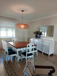 a dining room with a table and chairs and a mirror at Casa Sueño in Foz +28 photos