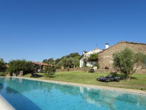 a large swimming pool in front of a house at Quinta da Alagoa in Santa Maria de Émeres