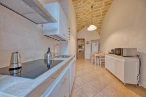 a kitchen with a sink and a counter top at Corte Anibaldi Apartment in Lecce